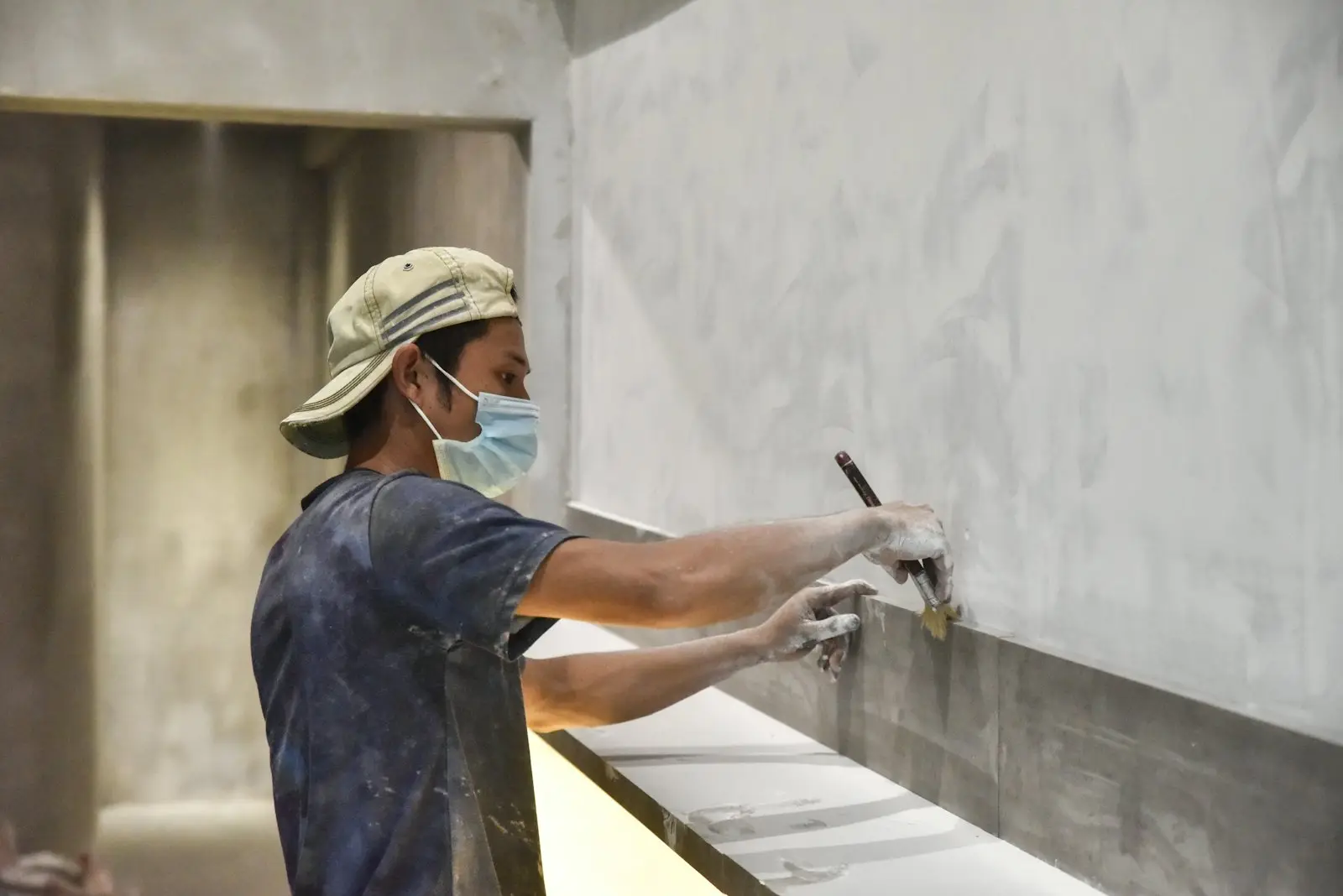 Oficial aplicando pañete sobre muro